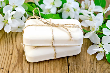 Image showing Soap with white flowers of apple on board
