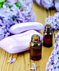 Image showing Oil with soap and lilacs on the board