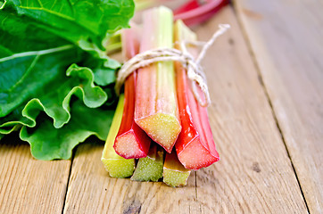 Image showing Rhubarb tied with twine with leaf on board