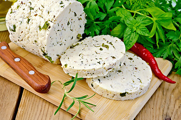 Image showing Cheese homemade with hot pepper and rosemary on board