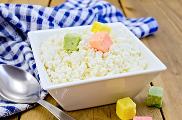 Image showing Curd with colored sugar and spoon on board