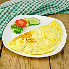 Image showing Omelet with vegetables and green napkin on board