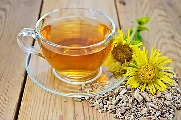 Image showing Herbal tea from root of elecampane with flower on board