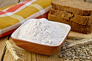 Image showing Flour rye in bowl with bread on board