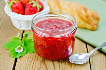 Image showing Jam of strawberry with bun and basket on board