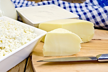 Image showing Cheese suluguni with curd and sour cream on board