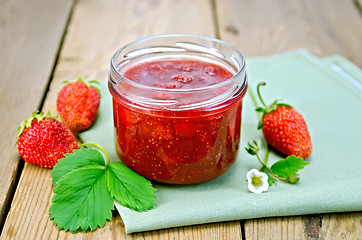 Image showing Jam of strawberry with berries and leaf on board