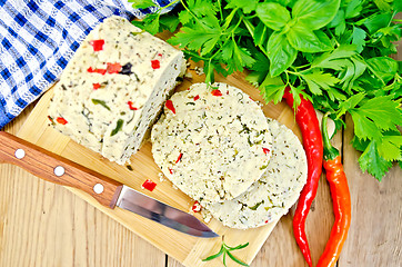 Image showing Cheese homemade with hot pepper and knife on board