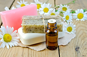 Image showing Oil with different soap and camomile on board