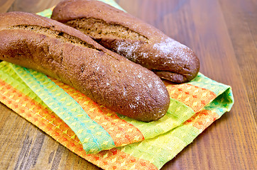 Image showing Rye baguettes on a napkin and board