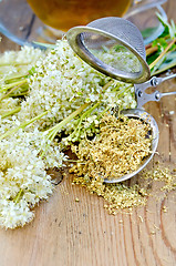 Image showing Herbal tea from meadowsweet with strainer and cup