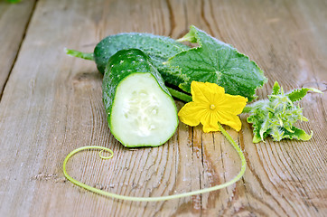 Image showing Cucumber sliced with a flower on board