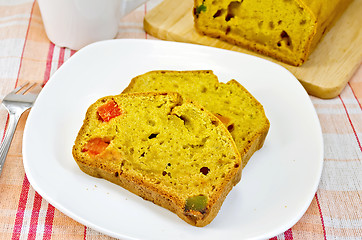 Image showing Fruitcake pumpkin with candied fruit on plate and napkin