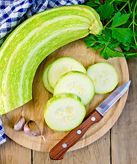 Image showing Zucchini green with garlic and knife on board