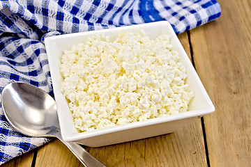 Image showing Curd with blue napkin and spoon on board