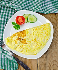 Image showing Omelet with green napkin on board