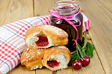 Image showing Bun with cherry jam and berries on board