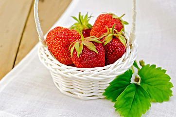 Image showing Strawberries in basket on napkin and board