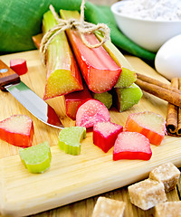 Image showing Rhubarb with sugar and knife on board