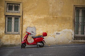 Image showing Bright red Vespa scooter in an urban street