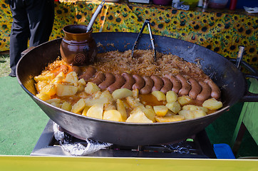 Image showing Potatoes, sausage cabbage meal baked in a huge pan 