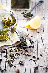 Image showing cup of green tea, spoon and lemon 