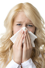 Image showing Ill woman with tissue is sneezing