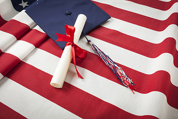 Image showing Graduation Cap and Diploma Resting on American Flag