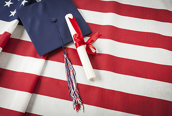 Image showing Graduation Cap and Diploma Resting on American Flag