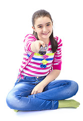 Image showing Happy little girl laying down and watching tv