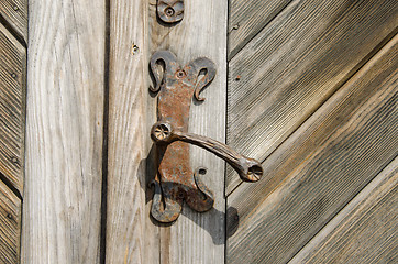 Image showing ancient manor door handle on old wooden door 