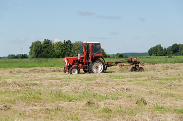 Image showing tractor ted hay dry grass in agriculture field 