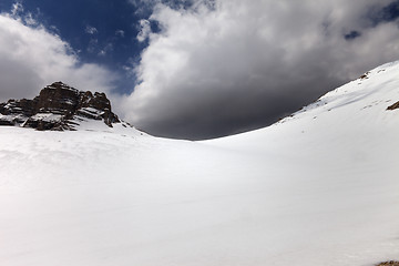 Image showing Snowy mountain pass and sky with storm clouds