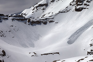 Image showing Mountains with snow cornice and traces from avalanches