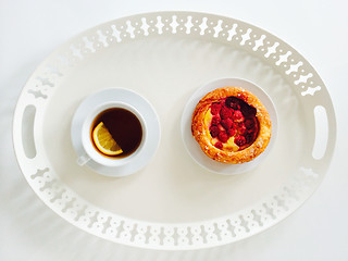 Image showing Tray with raspberry pastry and cup of tea