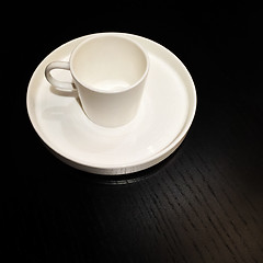 Image showing White cup on a black wooden table