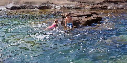 Image showing Children swimming in the sea