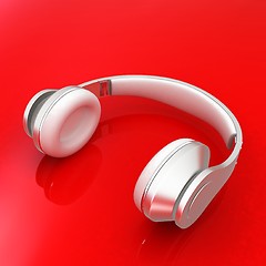 Image showing White headphones isolated on a red background 
