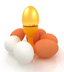 Image showing Eggs and gold easter egg on egg cups 