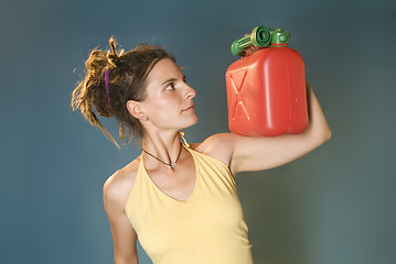 Image showing woman looks at petrol can