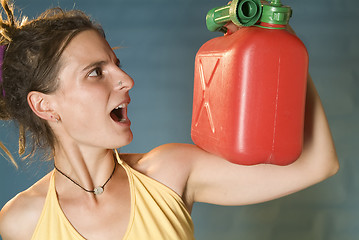 Image showing woman looks at petrol can