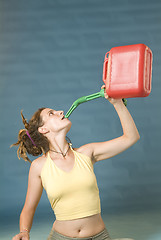 Image showing woman drinks of jerry can