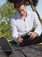 Image showing A smiling man with laptop