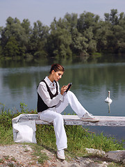 Image showing woman using PDA outdoors