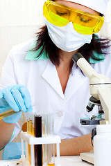Image showing doctor looking at a test tube of yellow solution