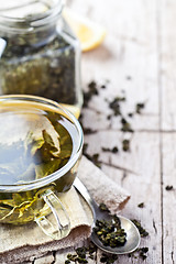 Image showing cup of green tea and lemon