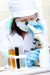 Image showing doctor looking at a test tube of yellow solution