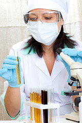 Image showing doctor looking at a test tube of yellow solution