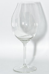 Image showing Broken clear wineglass with sharp glass fragments inside