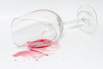 Image showing Broken wineglass with spilled splash of red wine